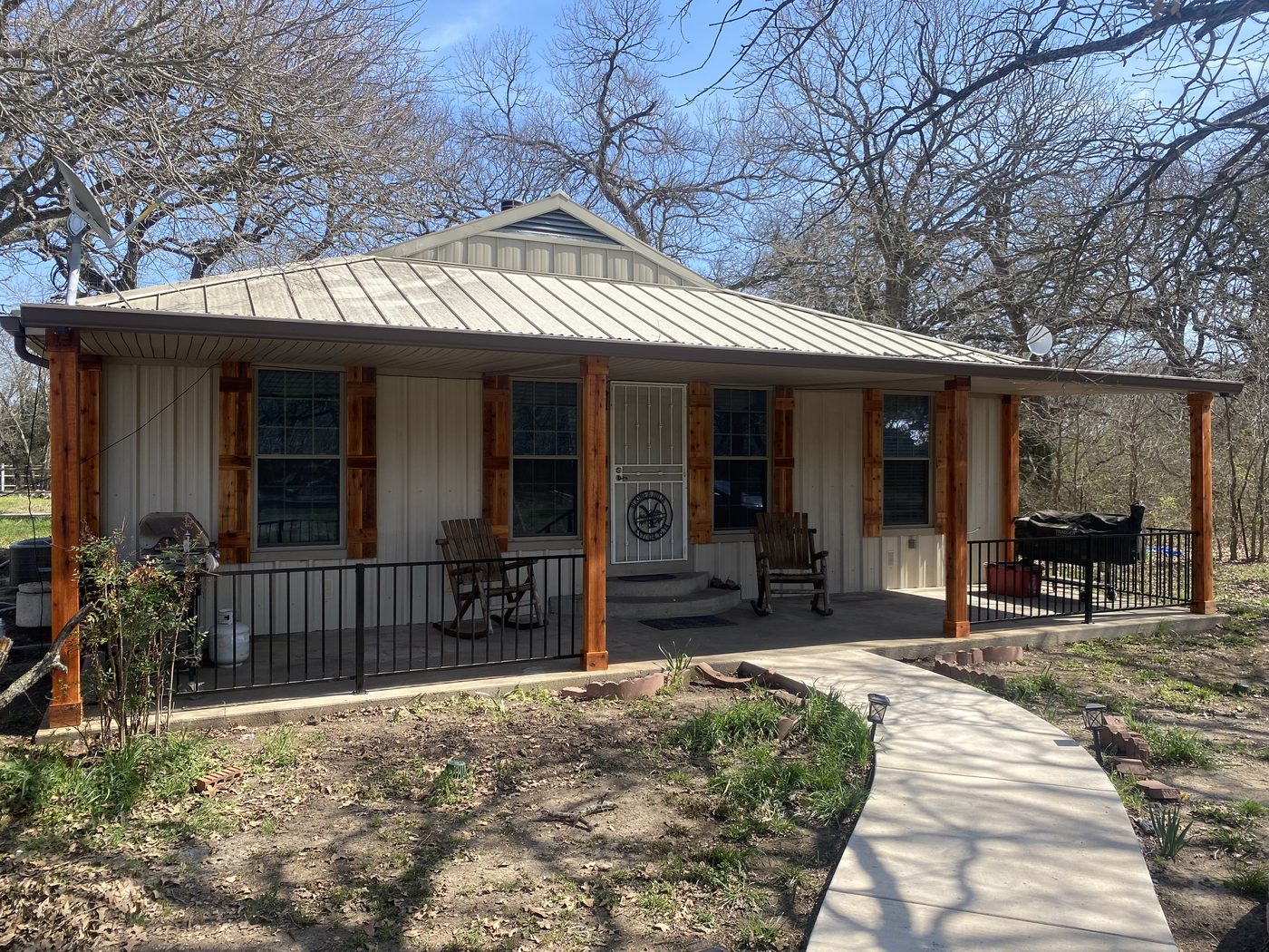 Finished porch remodel with new cedar columns and railing by Bravo Zulu Restoration
