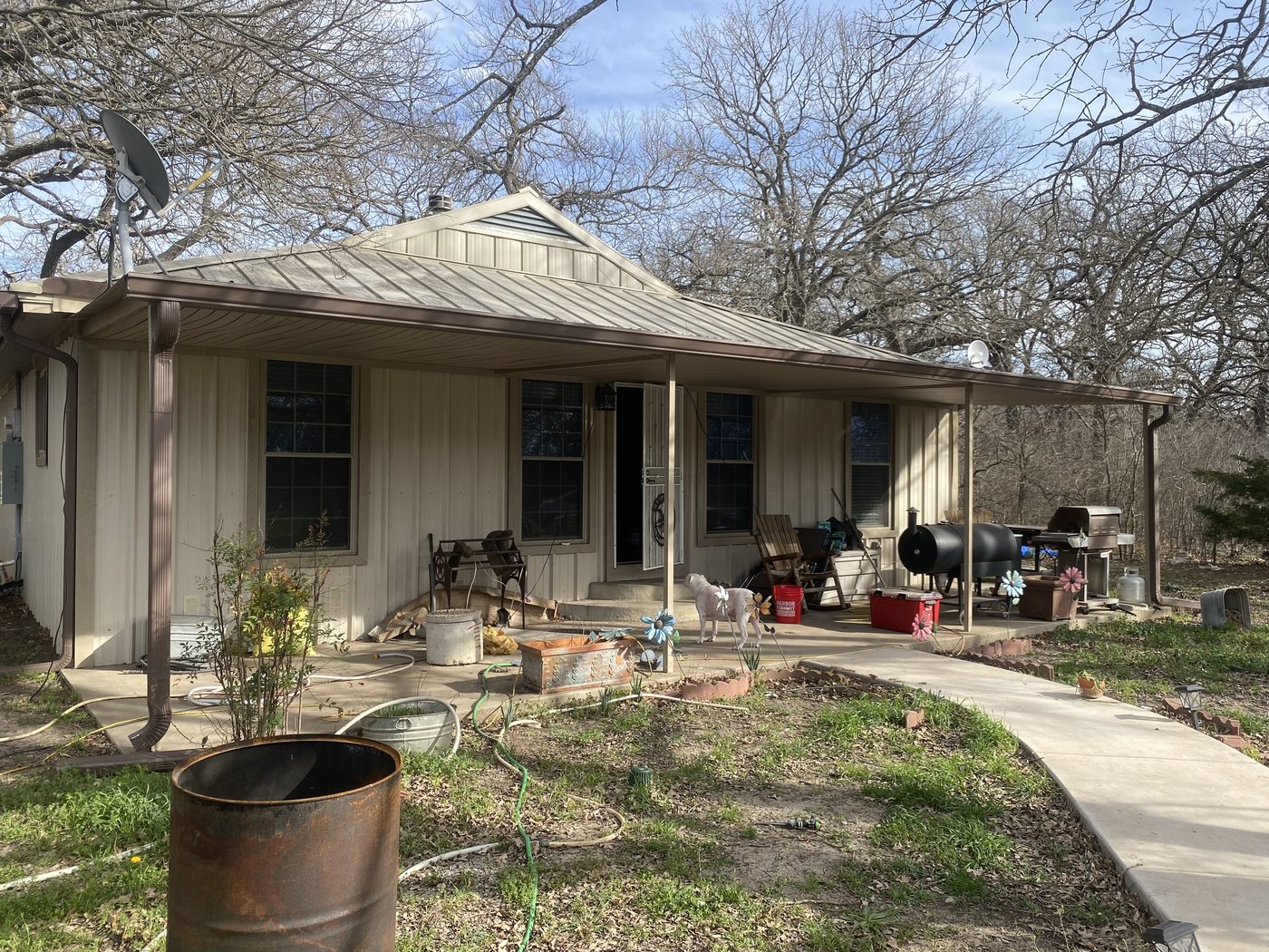 Home exterior with worn porch before remodel